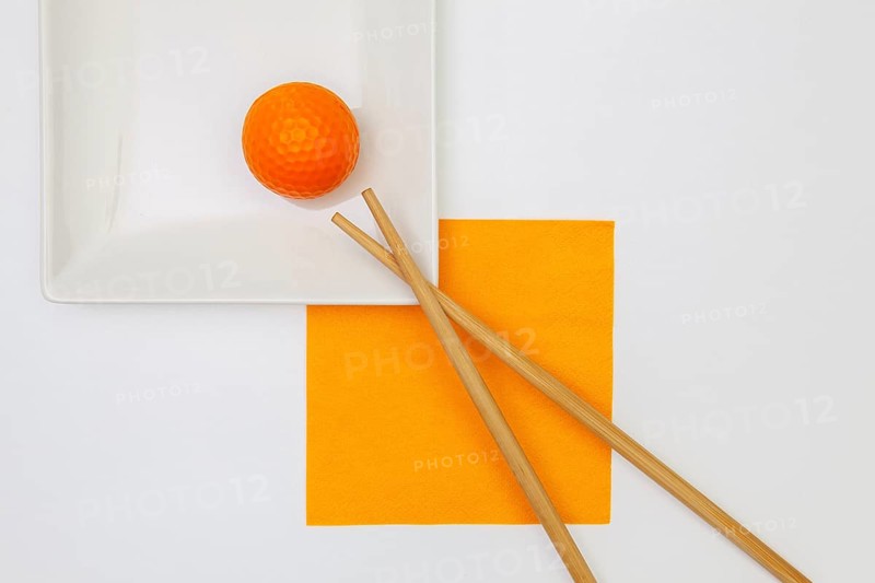 Top View Of White Empty Sushi Plates With Bamboo Chopsticks and Golf Ball. Golf Design