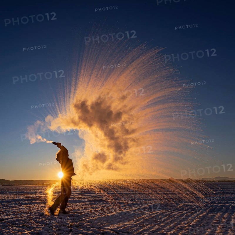 Woman throws hot water into the air that freezes into ice crystals, Mpemba effect, Unterallgäu, Bavaria, Germany, Europe