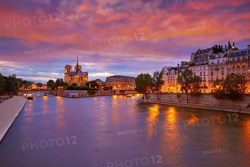 Notre Dame cathedral in Paris sunset from Seine river in France