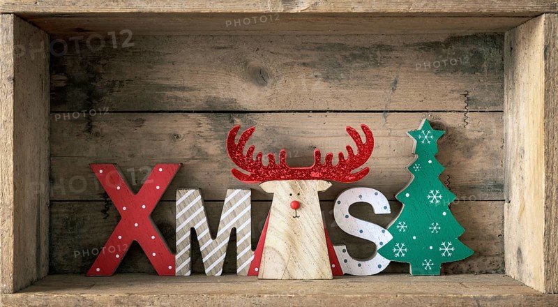A wooden reindeer with xmas text in a wooden box Christmas symbols decoration