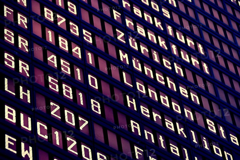 Close-up of information board at the airport with travel destinations