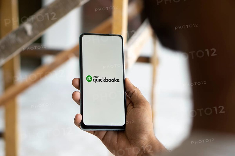 Intuit quickbooks logo is displayed on smartphone. QuickBooks is an accounting software.