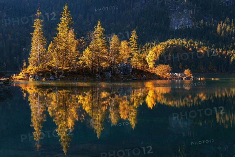 Lake Eibsee with a small island near mountain Zugspitze in south germany in fall