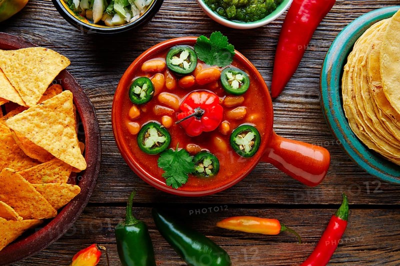 Frijoles charros mexican beans with chili pepper sides and tortillas