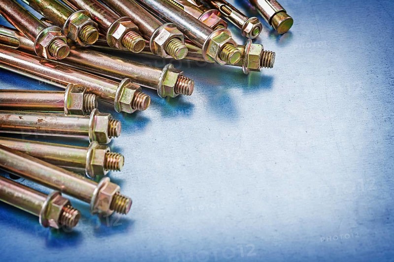 Variation of metal anchor bolts with construction nuts on metallic background repairing concept