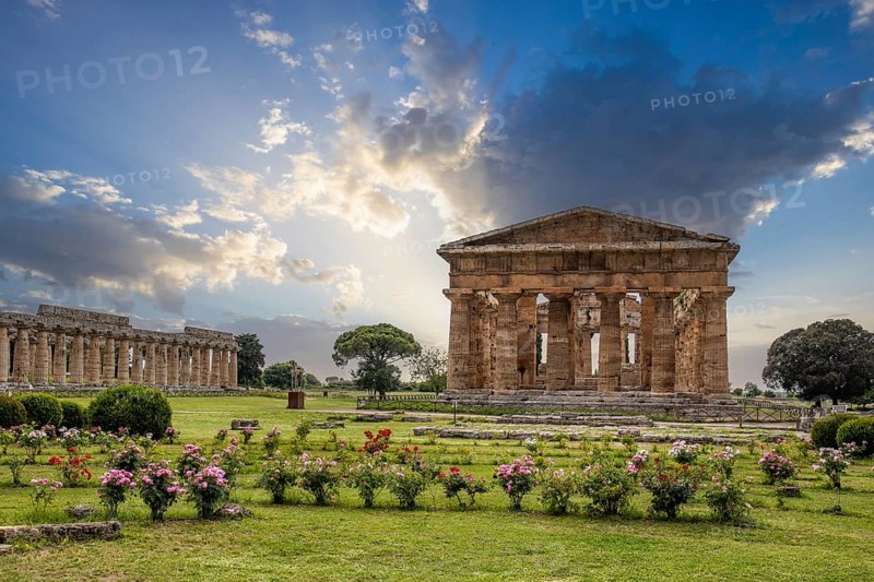 Beautiful old historical centre with ruins. Evening sunshine and the Temple of Athena in Paestum, Salerno, Italy, Europe