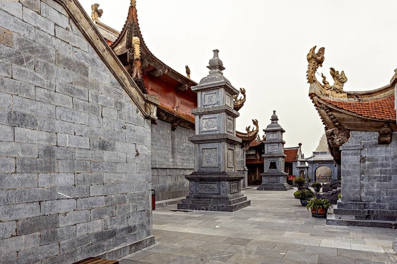 Inner courtyard with grey stone walls in traditional Asian architecture and decorated roofs, The temple complex at Fansipan near Sa Pa in Vietnam