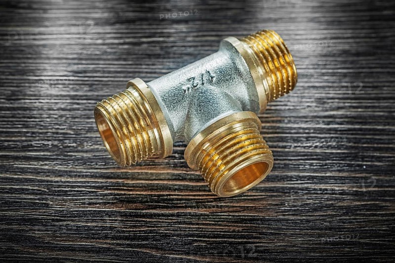 T-tube pipe connector on vintage wooden board