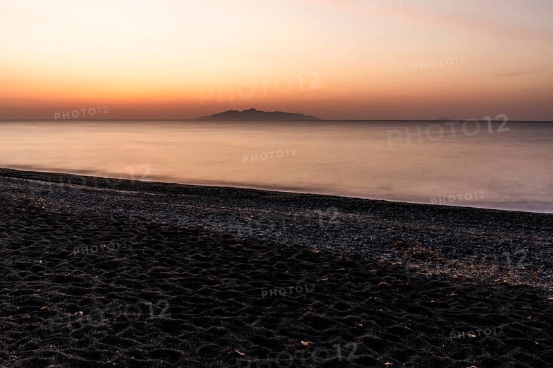 Dawn at sunrise, view from the lava beach near Kamari to the island of Anafi, long exposure, island of Santorini (Thira), Cyclades, Greek Islands, Greece, Europe