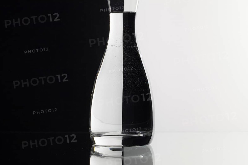 Glass of water on the black and white background on the glass table