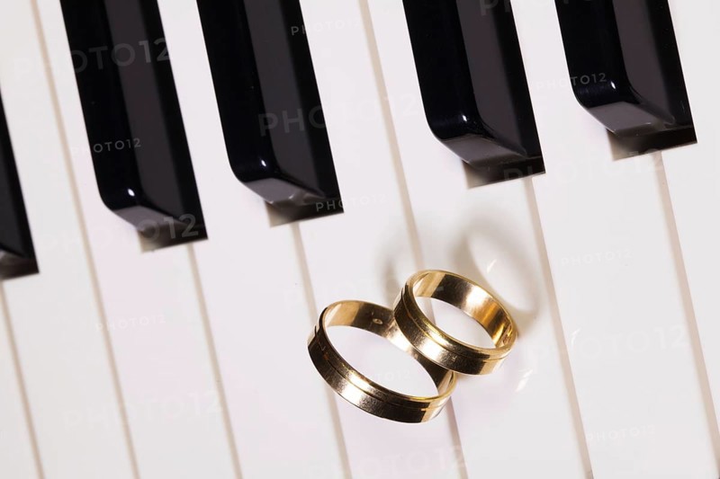 Detail of piano keyboard and wedding rings