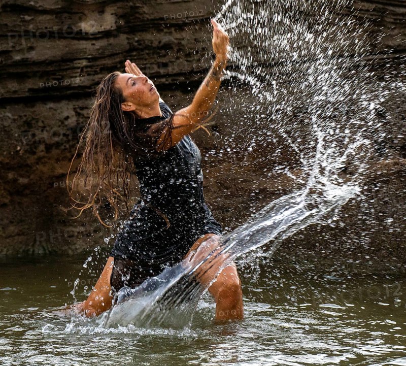 Middle-aged woman dancing and throwing water in the air, Maioris beach, llucmajor, Majorca, Balearic Islands, Spain, Europe