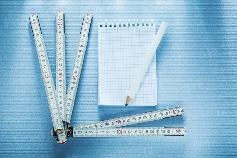 Notebook pencil measuring tape construction concept