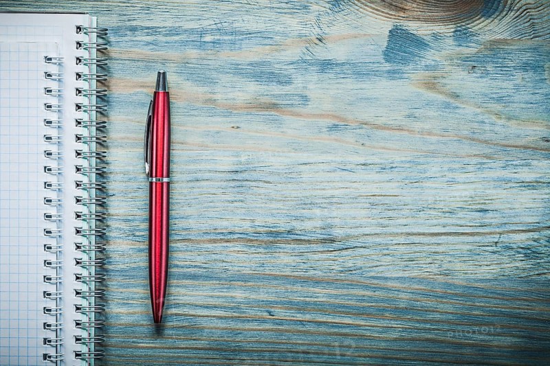 Blank note-books biro pen on wooden board copy space office concept