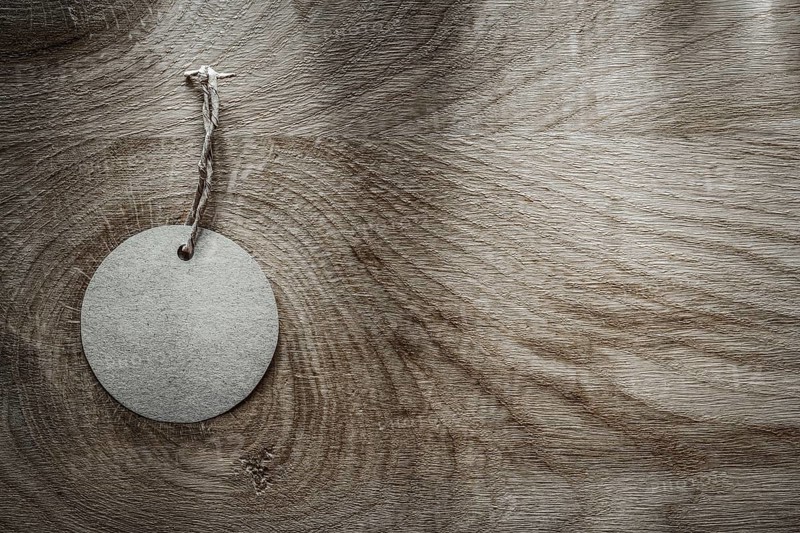 Round price tag on wooden board