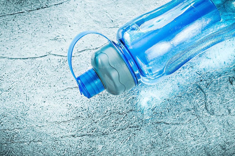Water bottle for doing sports on silver background fitness concept