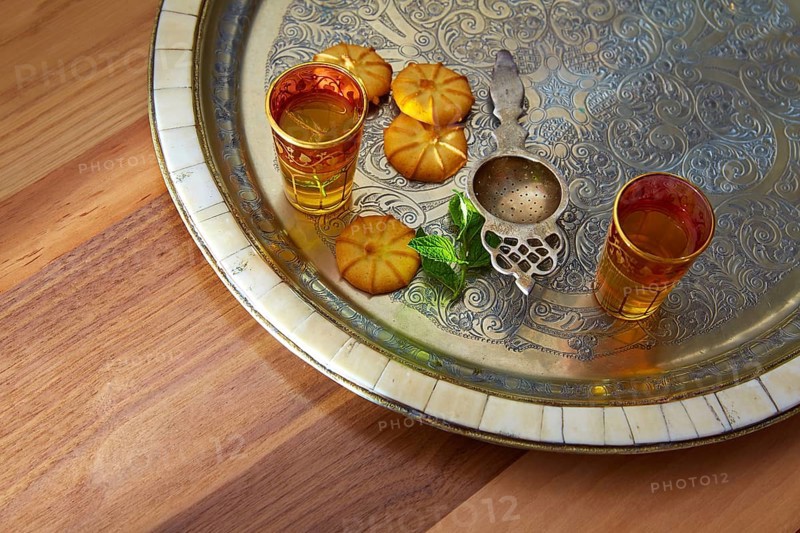 Green tea with mint Moroccan style on silver tray and biscuits