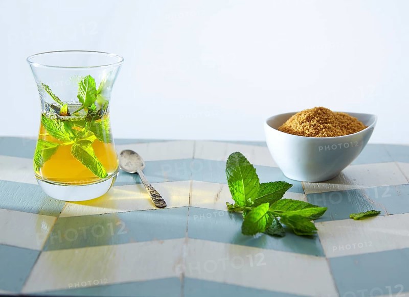 Green tea with mint Moroccan style on wood blue white table