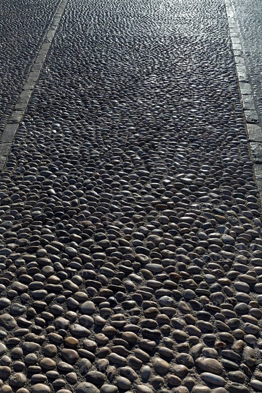 Rolling stones pavement soil texture in Altea Alicante mediterranean village of Spain