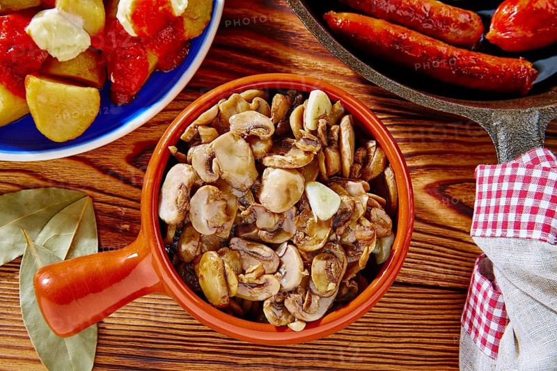 Tapas from Spain champinones mushrooms with potatoes and sausage