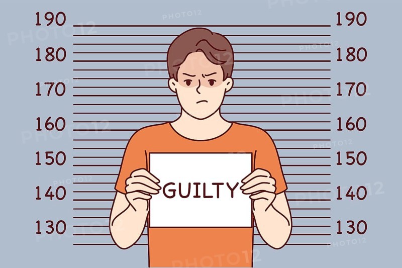 Man criminal with inscription guilty on sign stands near lines for measuring height of arrested bandit. Guilty guy who committed crime is detained by police and needs help of lawyer for court hearing
