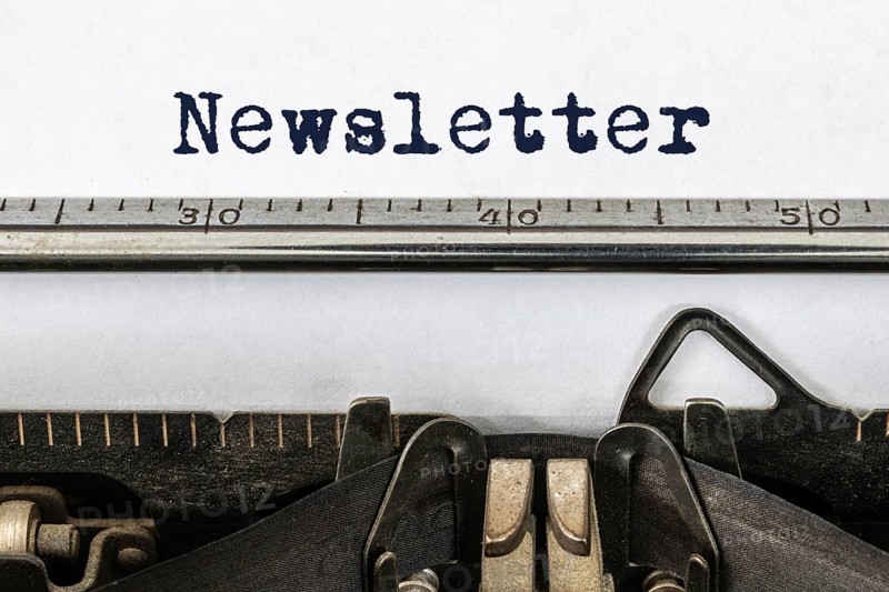 A vintage typewriter with the word newsletter