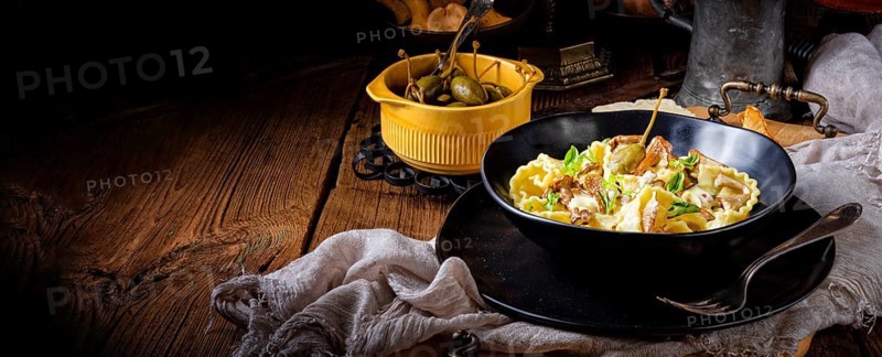 Reginette noodles in cream sauce with fresh chanterelles and capers