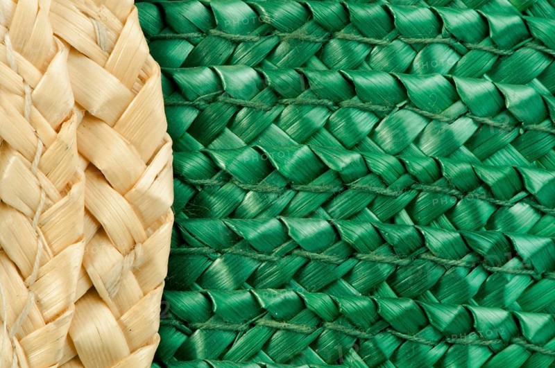 Woven straw natural background. Green and beige colors