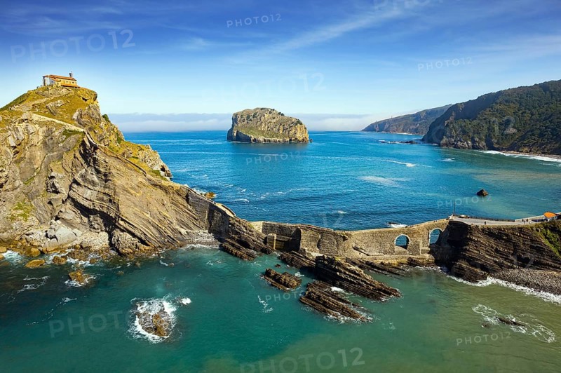 The most extraordinary coast of Spain. The island Gastelugache connected to the mainland by a bridge and a winding staircase. The Bay of Biscay, Basque Country. Photo taken from a drone