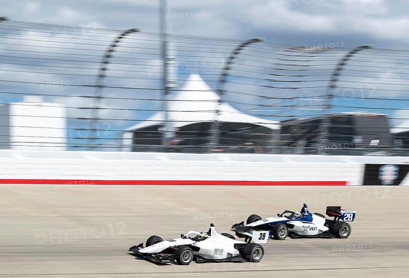 INDY NXT by Firestone Series driver, CHRISTIAN BROOKS (39) (R) of Santa Clarita, California races through the turns during the Big Machine Music City Grand Prix Presented by Gainbridge at Nashville Superspeedway in Lebanon, TN, Lebanon, United States of America, Asia