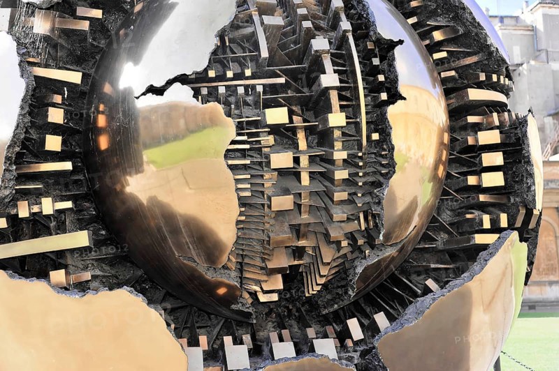Mappa Monda, Sfera con Sfera, Globe, Palazzetto del Belvedere, Cortile della Pigna, Vatican Museums, Vatican, Rome, Lazio, Italy, Metallic globe in the midst of people on a square in front of a building, Rome, Lazio, Italy, Detailed view of metallic and reflective structures of a sculpture, Vatican, Rome, Lazio, Italy, Europe