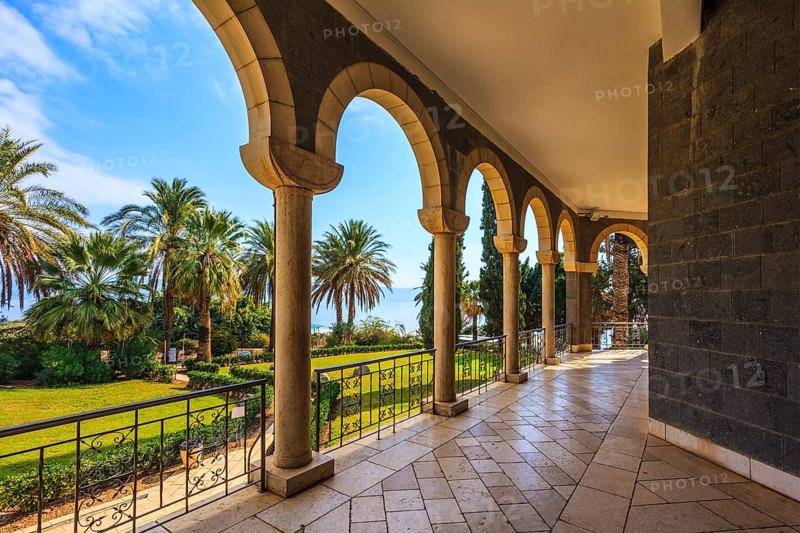 The basilica is surrounded by gallery with columns. Subtle shade of palms. Church Sermon on the Mount - Mount of Beatitudes