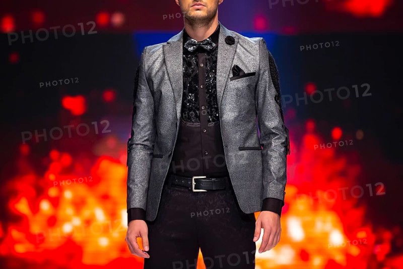 Female models walk the runway in beautiful dresses during a Fashion Show. Fashion catwalk event showing new collection of clothes. Unrecognizable people