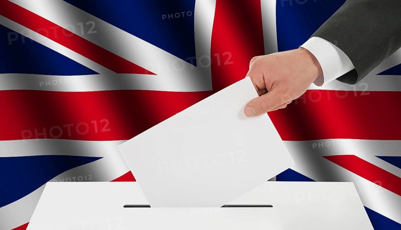 The British flag and the hand with the bulletin about the ballot box