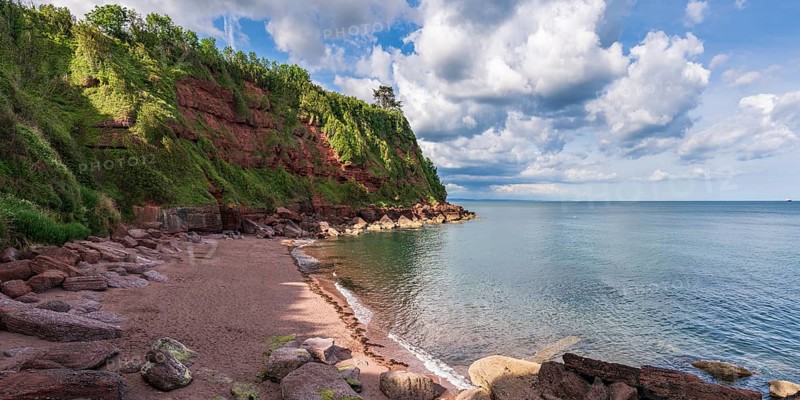 Clouds over the beach in Maidencombe, Torbay, England, UK