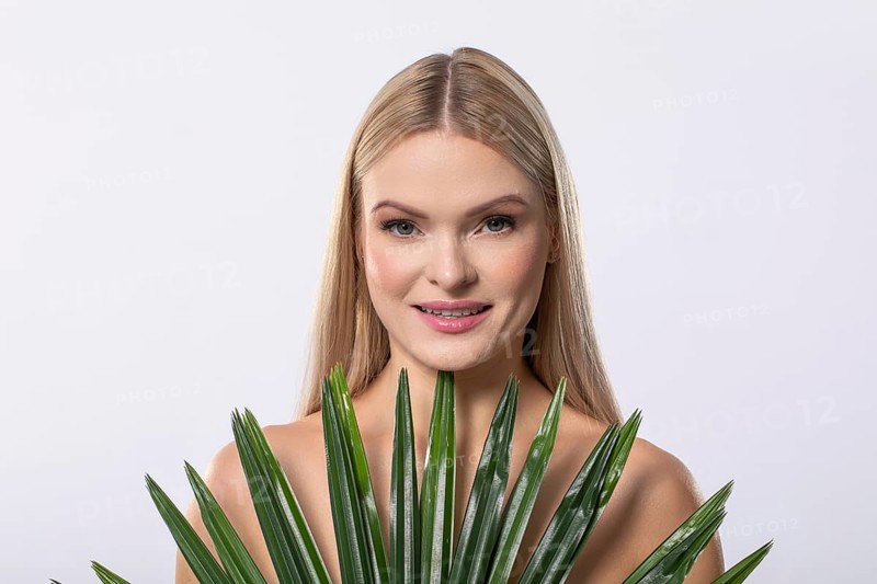 A serene, graceful woman gently cradling a lush aloe vera plant, embodying beauty, wellness, and natural elegance