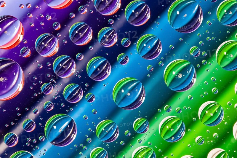 Color pencils under glass with drops of water. Office concept