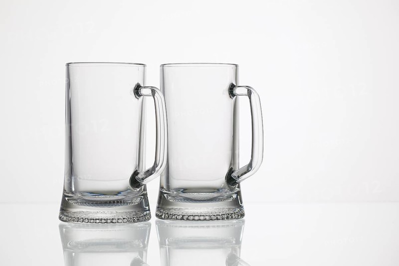 Empty glasses of beer on the glass desk