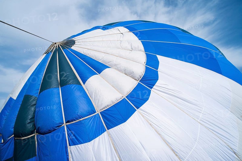Blue Balloon in the blue cloudy sky