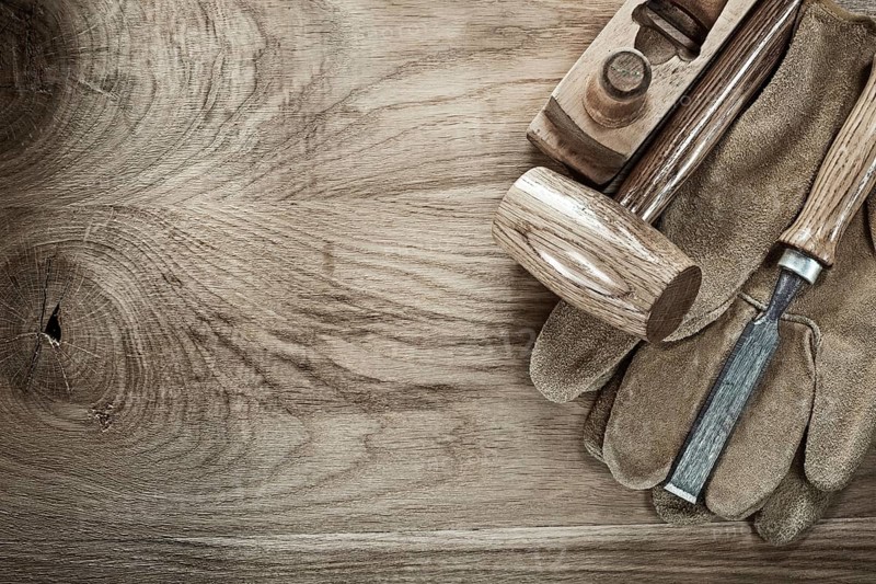 Wooden mallet shaving plane chisel protective gloves on wood board