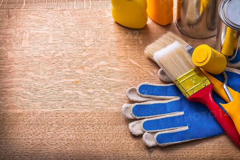 Work tools on protective gloves paint cans and bottles maintenance concept