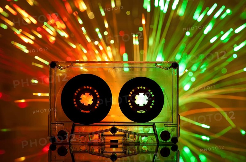 Cassette tape and multicolored yellow green lights on background