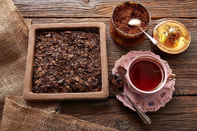 Bancha tea served pink vintage cup on wooden table board