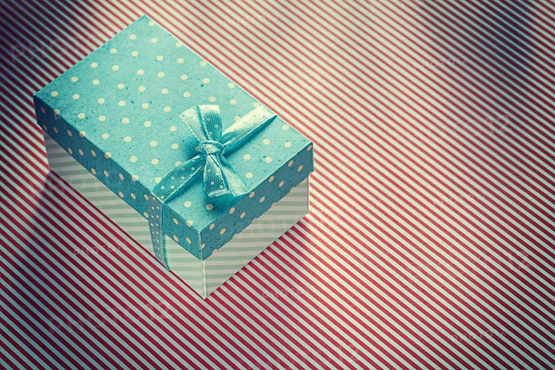 Present box on stripy tablecloth celebrations concept
