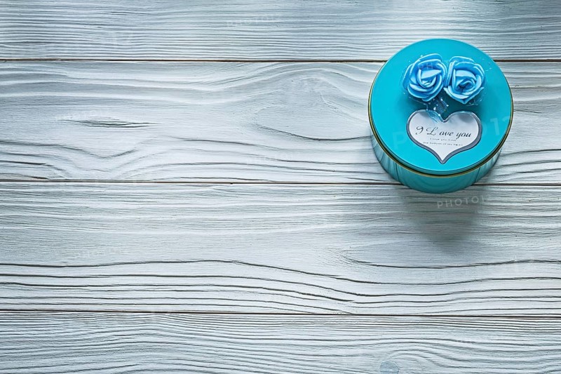 Round blue present box on wooden board celebrations concept