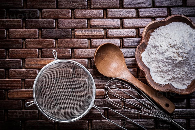Wooden spoon bowl with flower egg whisk and sieve