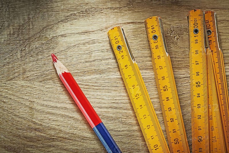 Wooden meter pencil on wood board construction concept