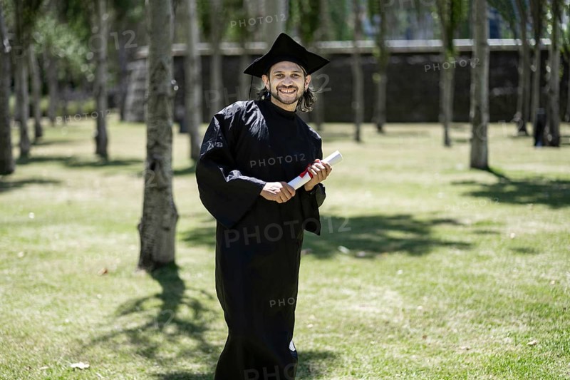 Portrait, student and happy man at graduation with certificate in university campus for success and achievement