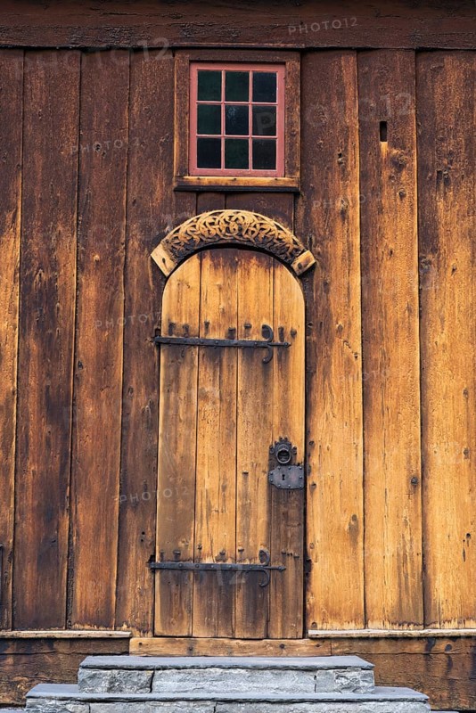 The famouse historic wooden church in Lom in Norway with blue sky summertime