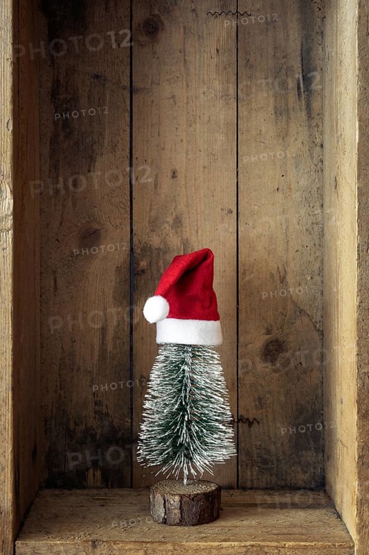 Christmas decoration Santa Claus hat and tree in a wooden box background
